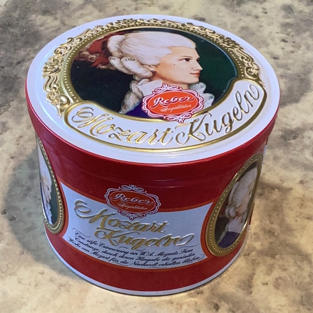 Red and White Circular Storage Tin with Elegant Design, empty